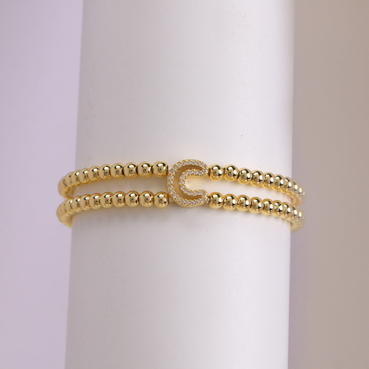 A cute and y 18k copper-plated bubble 26-letter elastic string beaded bracelet