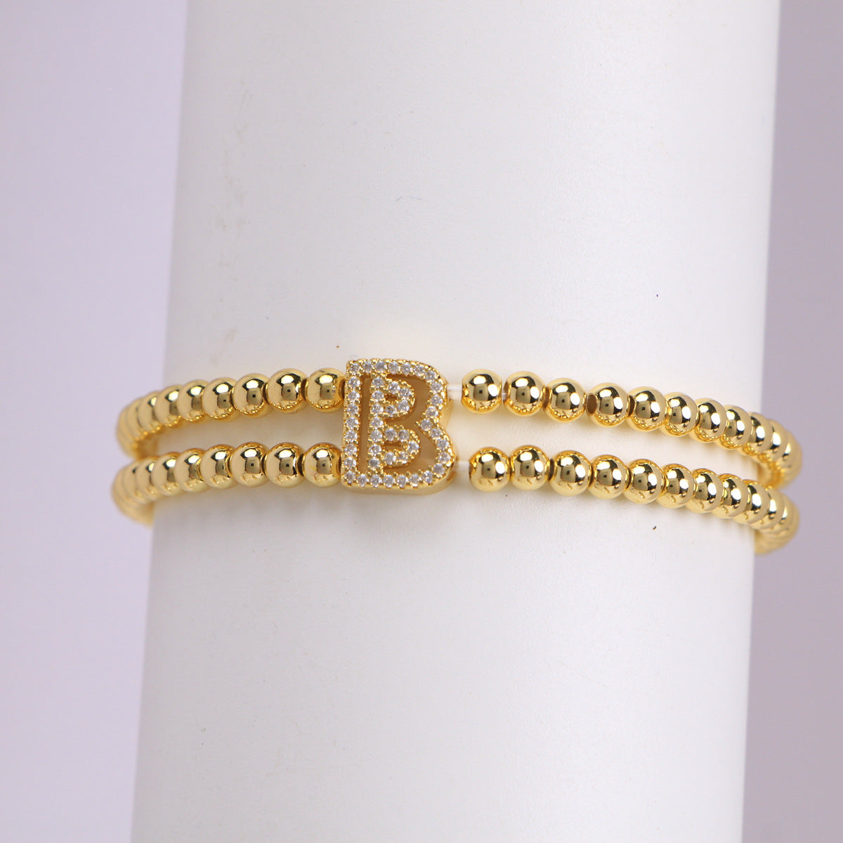 A cute and y 18k copper-plated bubble 26-letter elastic string beaded bracelet
