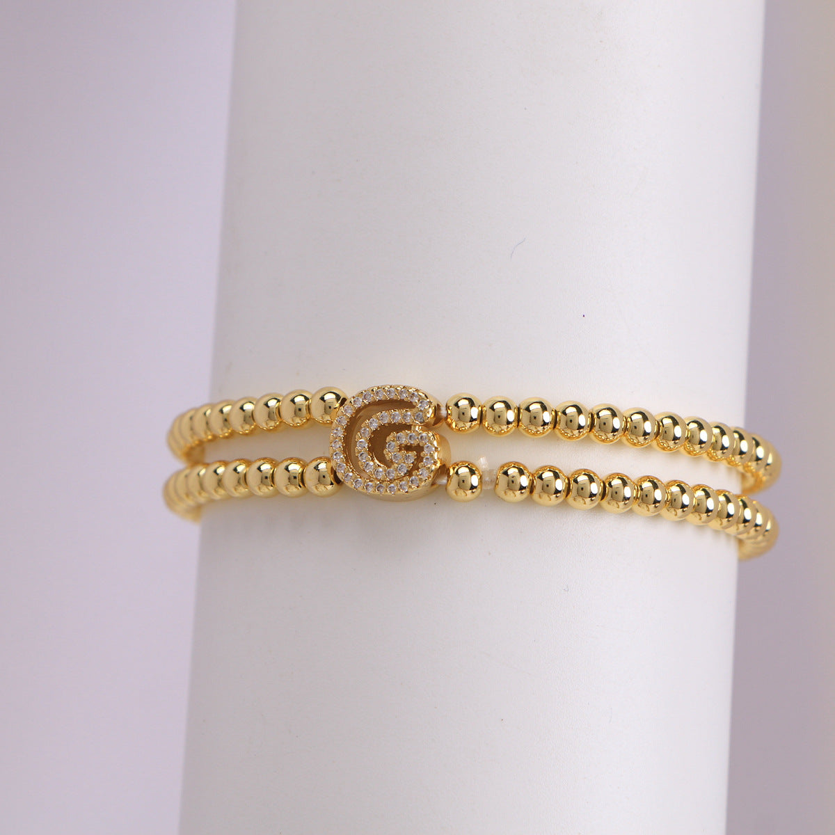 A cute and y 18k copper-plated bubble 26-letter elastic string beaded bracelet