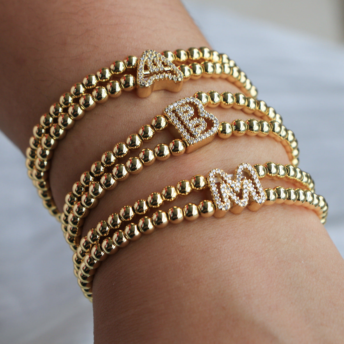 A cute and y 18k copper-plated bubble 26-letter elastic string beaded bracelet
