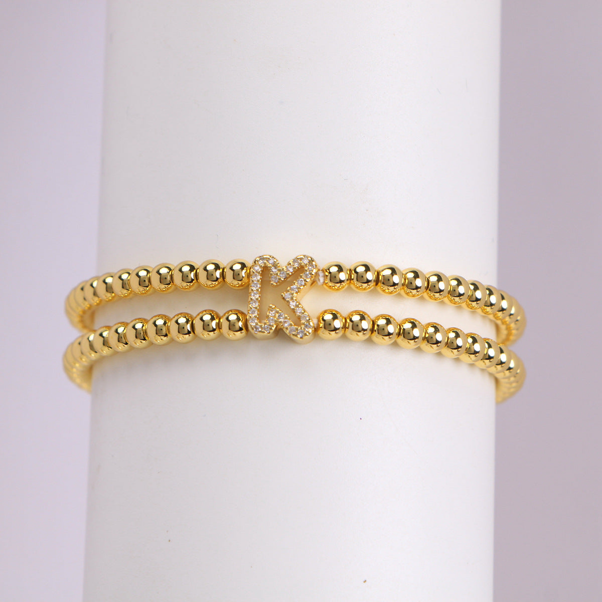 A cute and y 18k copper-plated bubble 26-letter elastic string beaded bracelet