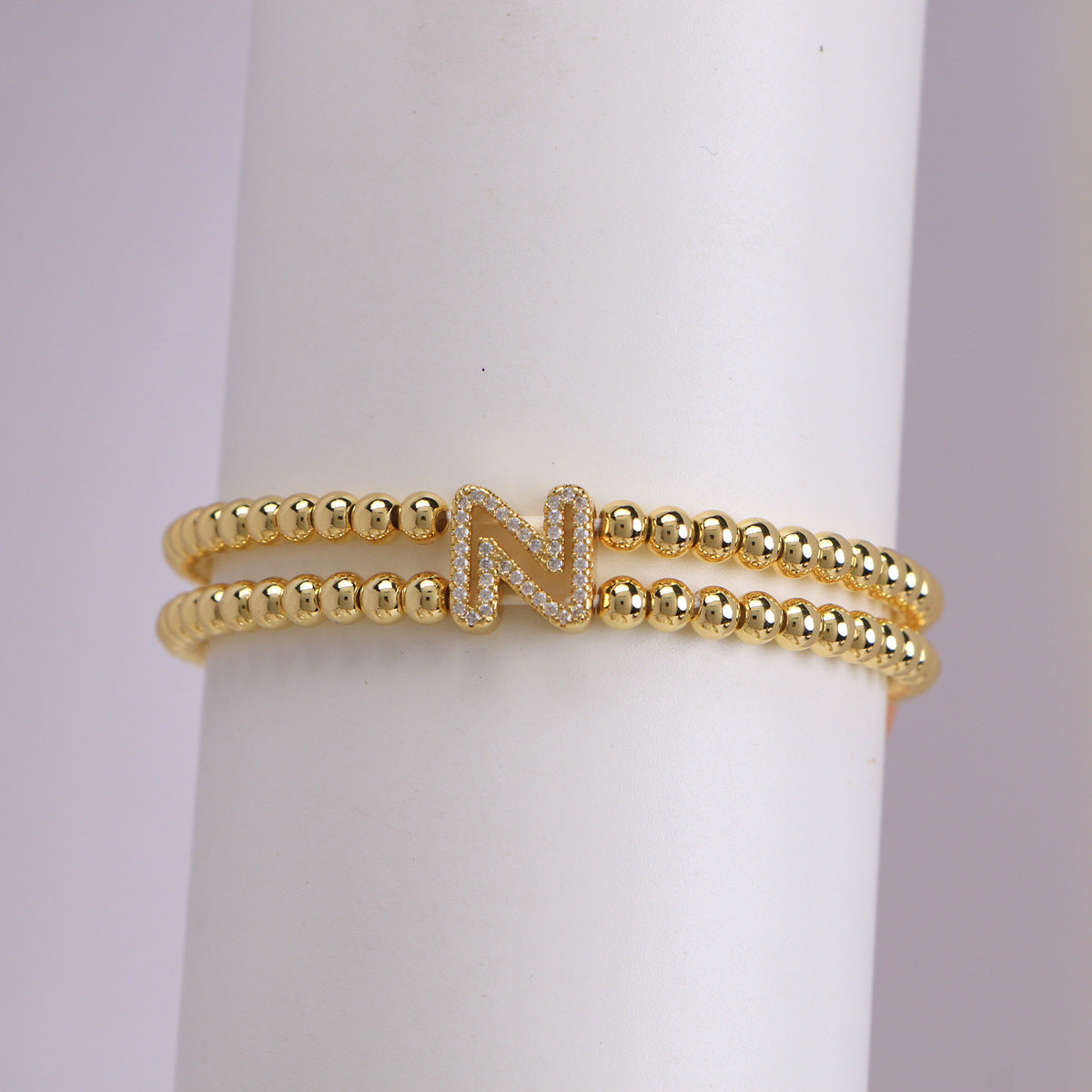 A cute and y 18k copper-plated bubble 26-letter elastic string beaded bracelet