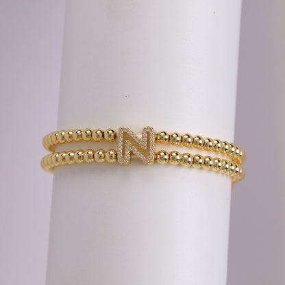 A cute and y 18k copper-plated bubble 26-letter elastic string beaded bracelet