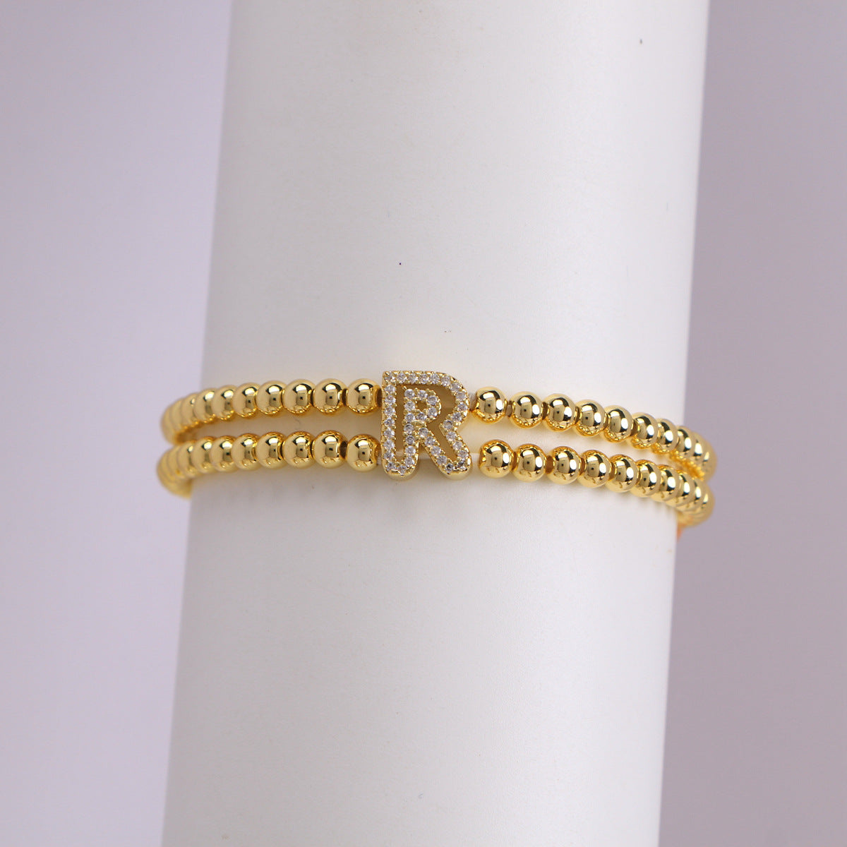 A cute and y 18k copper-plated bubble 26-letter elastic string beaded bracelet